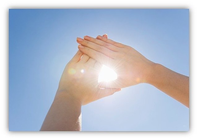Hands framing the sun