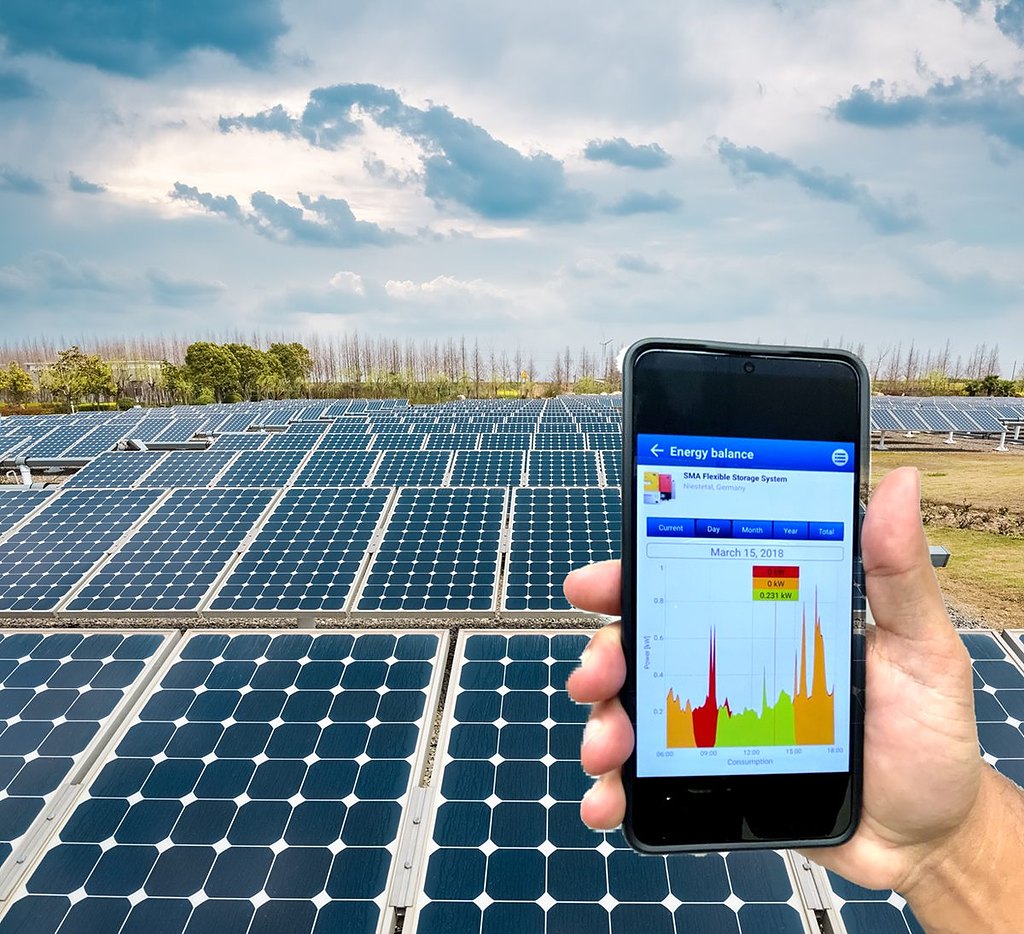 ecoSEMS monitoring on a phone in front of solar panels